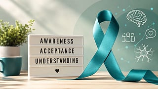 Awareness ribbon displayed beside the words “Awareness, Acceptance, Understanding,” representing efforts to improve public understanding of Tourette syndrome and reduce stigma surrounding the condition.