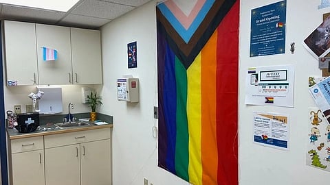 A rainbow flag displayed in a hospital hallway, symbolizing inclusivity and support for the LGBTQ+ community.