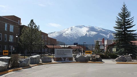 A secure research facility in Montana with snow-covered mountains in the background.