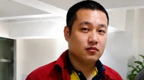Xu Bo in a red jacket and yellow t-shirt.