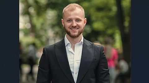 Liubomyr in a suit with a white shirt.