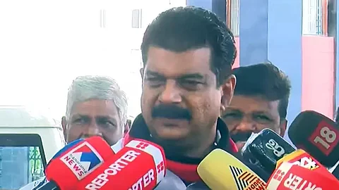 PV Anwar MLA with a shawl in DMK colors around his neck