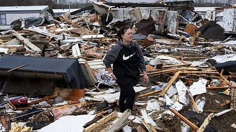 A woman searches through the rubble of her tornado-damaged home in Poplar Bluff, Missouri.