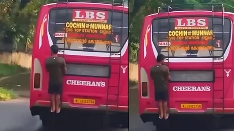 Interstate worker hangs from behind bus