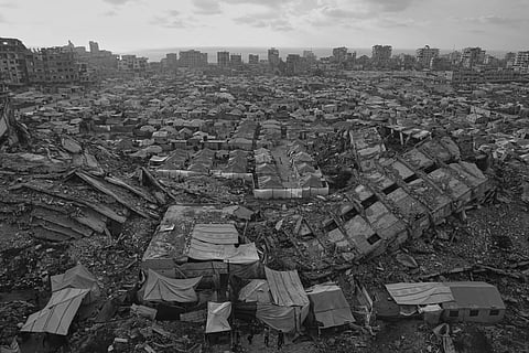 A tent camp for displaced Palestinians stretches among the ruins of buildings destroyed by Israeli bombardments in west Gaza City, Saturday, June 21, 2025.