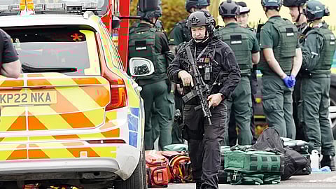 An armed police officer at the scene of a stabbing incident at Heaton Park Hebrew Congregation synagogue, in Crumpsall, Manchester, England, Thursday Oct. 2, 2025.