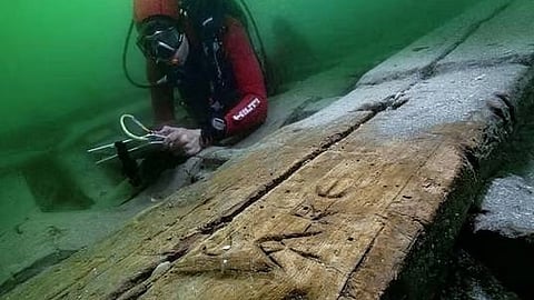 A diver looks at a wreckage with Greek inscriptions near the sunken island of Antirhodos.