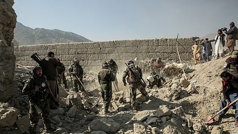 Taliban security personnel search for victims after an overnight Pakistani air strike hit a residential area at the Girdi Kas village in Bihsud district, Nangarhar province.