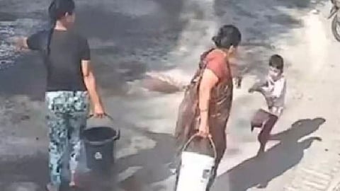 Grandmother pours boiling water on child for spilling colored water during Holi celebrations