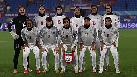 Iran players stand in silence during national anthem in first match of tournament