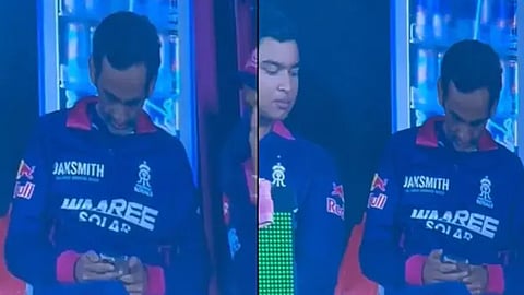 rajasthan royals manager uses mobile phone in dugout during match against rcb