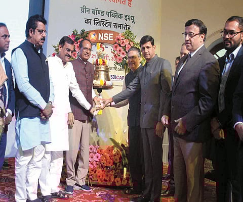 Chief Minister Shivraj Singh Chouhan rings a bell during a ceremony for listing of green bonds of Indore Municipal Corporation on National Stock Exchange, at Kushabhau Thackeray Convention Centre