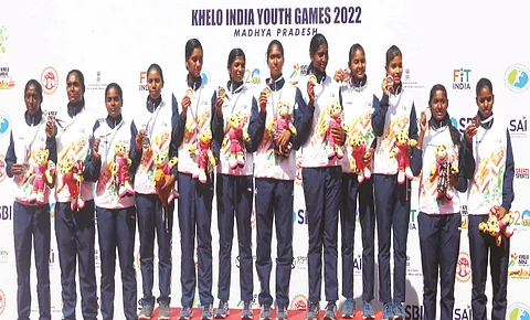 Gold medalist team players (C) from Kerala, silver medalist team players (L) from Tamil Nadu and bronze medalist team players (R) from Odisha pose for the photographs