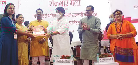 Union Minister for Civil Aviation Jyotiraditya Scindia distributes appointment letters to a beneficiary   during a Rozgar Mela, at Samanvay Bhawan   in Bhopal on Thursday.