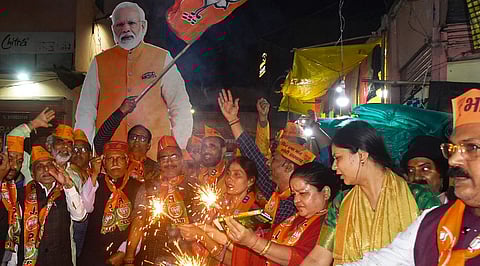 BJP workers celebrate the announcement of Prime Minister Narendra Modi contesting from Varanasi for the third time after BJP released its first list of candidates for the upcoming Lok Sabha elections, in Varanasi, Saturday, March 2, 2024.