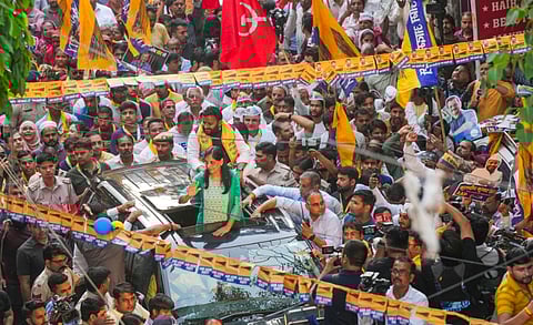 Jailed Delhi Chief Minister Arvind Kejriwal's wife Sunita Kejriwal greets supporters during an election roadshow in support of Aam Aadmi Party's (AAP) candidate from East Delhi constituency Kuldeep Kumar for the Lok Sabha polls, in New Delhi, Saturday, April 27, 2024.