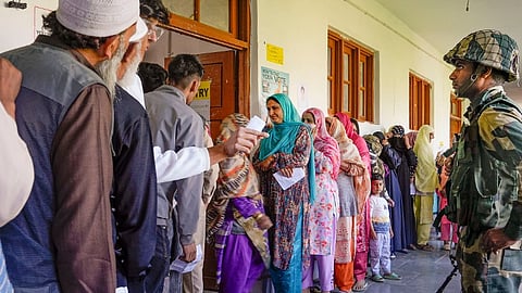 People wait in queues to cast their votes during the fifth phase of Lok Sabha elections, at a polling booth in Sopore, in Baramulla district, Monday, May 20, 2024.