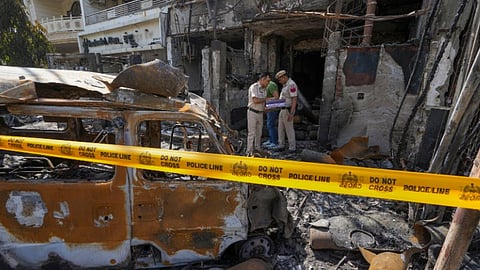 Police personnel investigate at the Baby Care Hospital after a fire broke out that killed seven newborns, in east Delhi, Sunday, May 26, 2024.