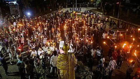 People take part in a torch light protest against Prajwal Revanna, in Bengaluru, Thursday, May 2, 2024.