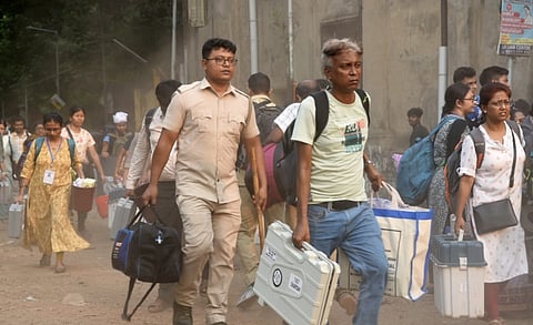 Polling officials leave for their respective polling booths after collecting election material from a distribution centre on the eve of the fifth phase of Lok Sabha elections, in Hooghly district, Sunday, May 19, 2024.