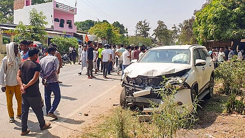 People gather near an escort vehicle, part of the convoy of Brij Bhushan Sharan Singh's son and BJP leader Karan Bhushan Singh, that allegedly hit a biker, in Gonda, Wednesday, May 29, 2024.