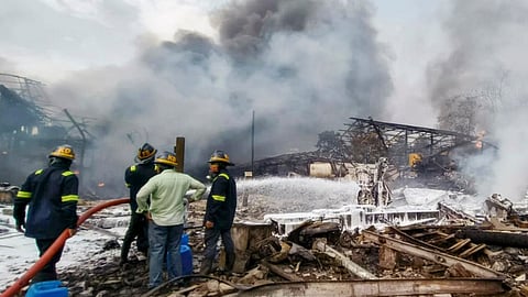 Firefighters try to extinguish a fire that broke out due to a boiler blast in a chemicals factory, at Dombivli, in Thane district, Thursday, May 23, 2024.