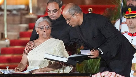 BJP MP Nirmala Sitharaman signs as minister during the swearing-in ceremony of new Union government, at Rashtrapati Bhavan in New Delhi, Sunday, June 9, 2024.