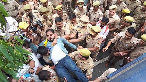 AAP party worker being detained during a protest against the arrest of party convenor and Delhi CM Arvind Kejriwal, in New Delhi.