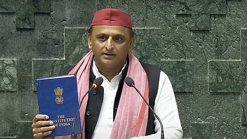 Samajvadi Party MP Akhilesh Yadav shows a copy of Constitution of India as he takes oath as a member of the House during the first session of the 18th Lok Sabha, in New Delhi, Tuesday, June 25, 2024.