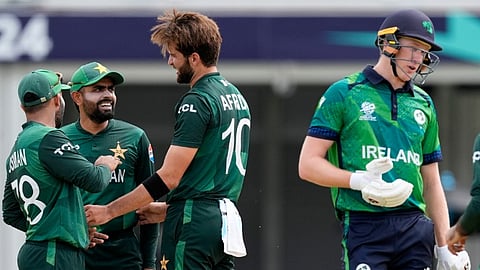 Ireland's Harry Tector, right, leaves the field after losing his wicket to Pakistan's Shaheen Shah Afridi, center, during the ICC Men's T20 World Cup cricket match between Ireland and Pakistan at the Central Broward Regional Park Stadium, Lauderhill, Fla., Sunday, June 16, 2024.