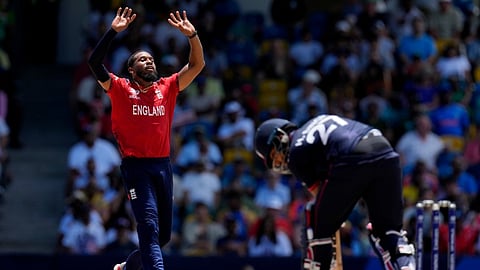 England's Chris Jordan, left, reacts after bowling a delivery to United States' Harmeet Singh, right, during the ICC Men's T20 World Cup cricket match between the United States and England at Kensington Oval in Bridgetown, Barbados, Sunday, June 23, 2024.