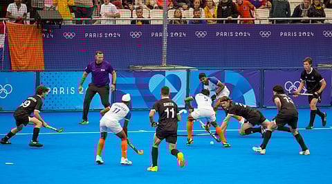 India's Abhishek (5) with Mandeep Singh (11) and New Zealand's players vie for the ball during the Pool B hockey match between India and New Zealand, at the Summer Olympics 2024, in Paris, Saturday, July 27, 2024.