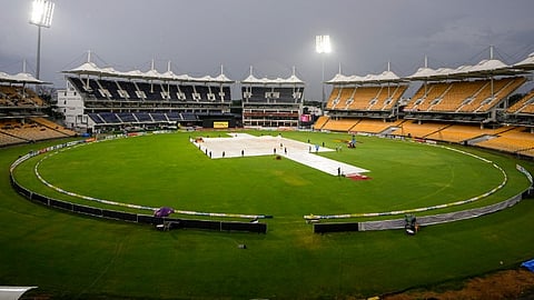 Ground staff covers the pitch as rain stops play during the second T20 cricket match of a series between India Women and South Africa Women, at the MA Chidambaram Stadium, in Chennai, Sunday, July 7, 2024.