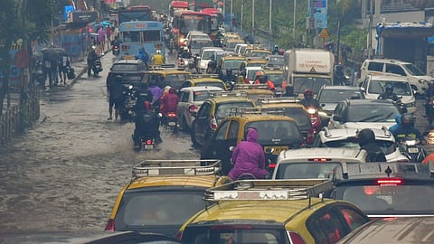 Vehicles move on a waterlogged road after heavy monsoon rain, at Dadar in Mumbai, Sunday, July 21, 2024.