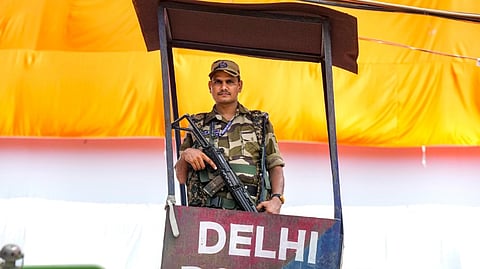 A security official stands guard at the Red Fort premises ahead of the Independence Day celebrations, in New Delhi, Wednesday, Aug. 14, 2024.