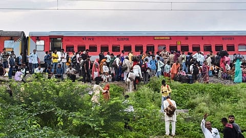 Passengers outside the Sabarmati Express after twenty coaches of the train derailed near Govindpuri station, in Kanpur, Saturday, Aug. 17, 2024.