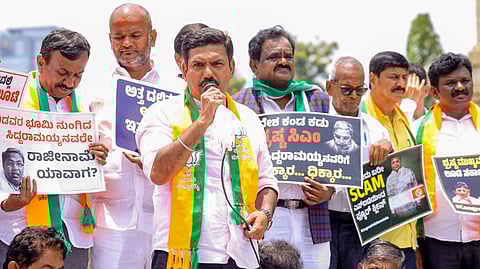 Karnataka BJP President B.Y. Vijayendra with party leaders during a protest against state Chief Minister Siddaramaiah over the alleged MUDA scam, near Mahatma Gandhi's statue at Vidhana Soudha, in Bengaluru, Monday, Aug. 19, 2024.