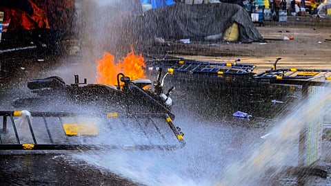 A police bike after it was set on fire by some miscreants during a protest march of students towards West Bengal Secretariat over the alleged sexual assault and murder of a trainee doctor, in Kolkata, Tuesday, Aug. 27, 2024.