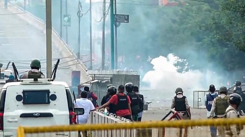 Media photographers cover clashes between students and security personnel during a protest over recent violence, in Imphal, Tuesday, Sept. 10, 2024.