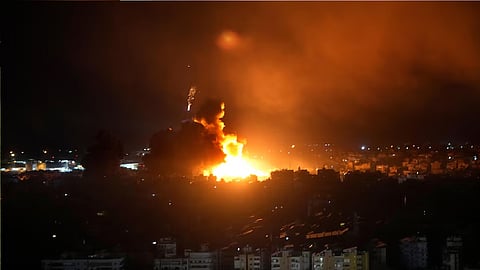 Israeli airstrikes rock southern suburbs of Beirut and cut off key crossing into Syria