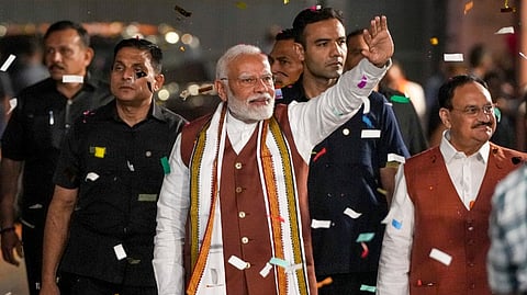 Prime Minister Narendra Modi greets the gathering upon his arrival at the party headquarters during an event after the declaration of results for the Haryana and Jammu and Kashmir Assembly elections, in New Delhi, Tuesday, Oct. 8, 2024.