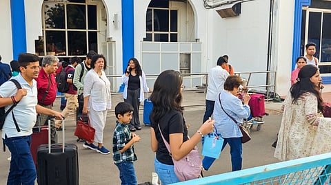 Passengers outside Jodhpur airport after an Indigo's Pune-Jodhpur flight was diverted to Ahmedabad airport following a bomb threat, in Jodhpur, Sunday, Oct. 27, 2024.