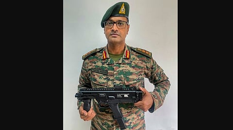 Indian Army Colonel Prasad Bansod shows 'Asmi' machine pistol, indigenously developed by him in collaboration with the DRDO.