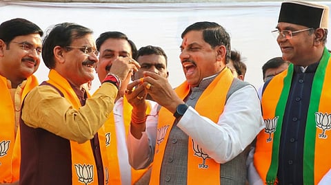 Madhya Pradesh Chief Minister Mohan Yadav with state BJP President VD Sharma celebrates the party's victory in the Maharashtra Assembly elections and the state's Budhni Assembly constituency bypoll, in Bhopal, Saturday, Nov. 23, 2024.
