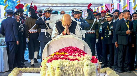 BJP leader and Home minister Amit Shah paying respects to the body of former prime minister Manmohan Singh, in New Delhi, Saturday, Dec. 28, 2024.