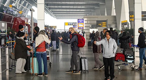 Passengers at the Indira Gandhi International Airport during a cold and foggy winter morning, in New Delhi, Saturday, Jan. 4, 2025.