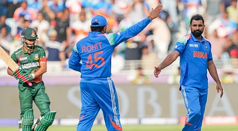 India's Mohammed Shami, right, celebrates with captain Rohit Sharma after taking the wicket of Bangladesh's Tanzim Hasan Sakib during a One Day International (ODI) cricket match of the ICC Champions Trophy between India and Bangladesh, at Dubai International Cricket Stadium, in Dubai, UAE, Thursday, Feb. 20, 2025.