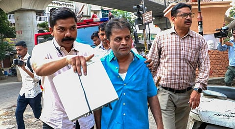 Nagpur Crime Branch detains Haji Mukim Khan, blue shirt, in connection with the Chitnis Park area riots, in Nagpur, Wednesday, March 19, 2025.