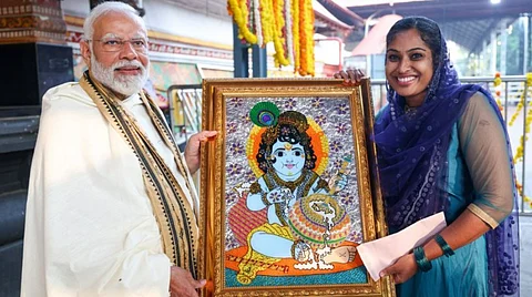 PM Modi receiving a painting of Guruvayoor Kannan (Lord Krishna) from artist Jasna Salim, during his recent visit to Kerala.
