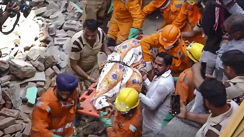 Mustafabad, came crashing down like a stack of cards, trapping several people under the rubble.